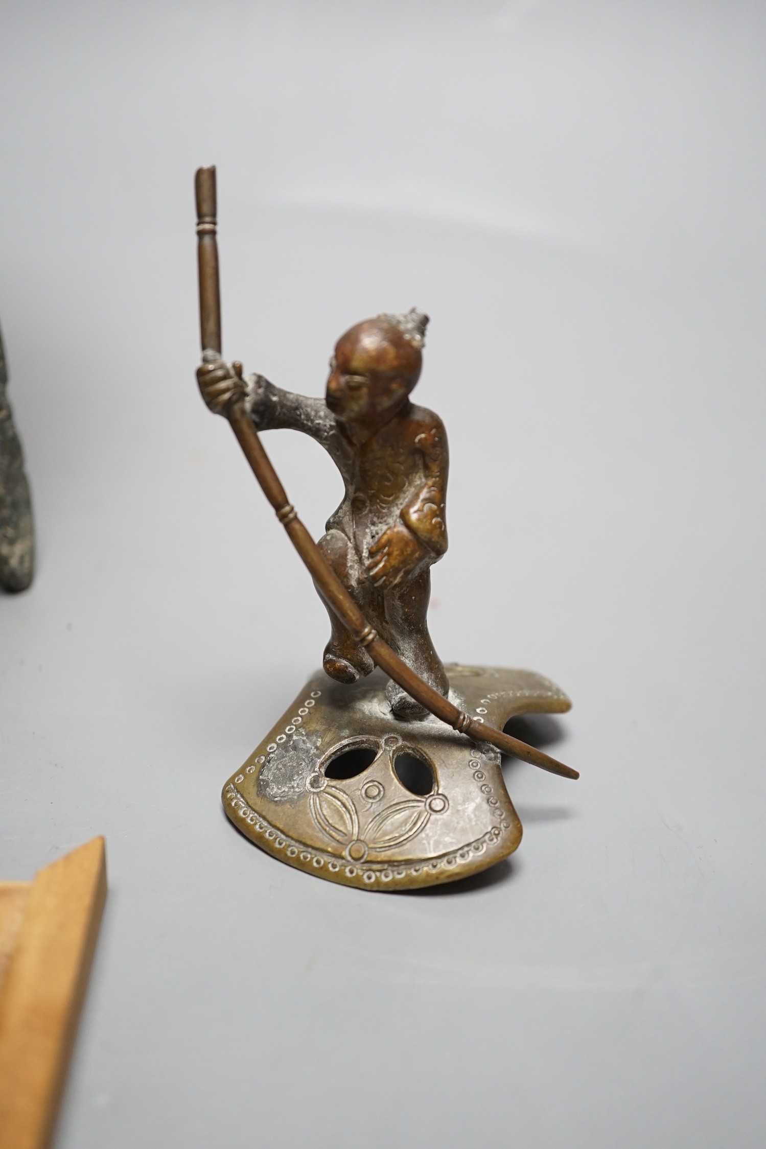A Chinese green and russet jade belt buckle, an archaistic bronze tripod vessel and a figural bronze. Tallest 25cm